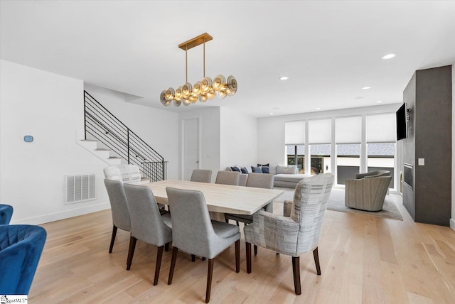 dining space with baseboards, recessed lighting, light wood-style flooring, stairs, and visible vents