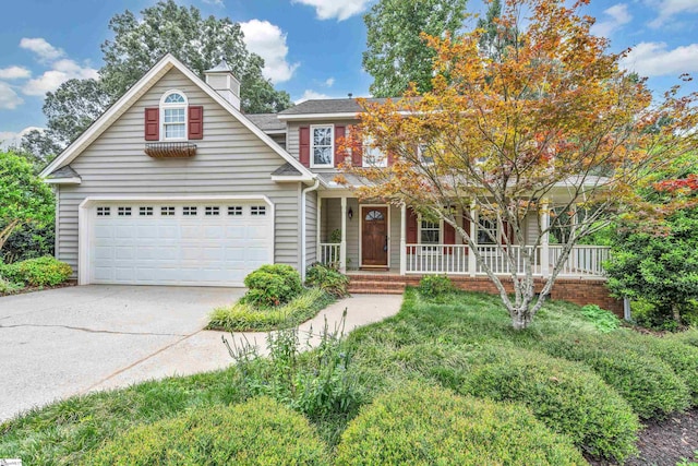 traditional home with a garage, covered porch, and driveway