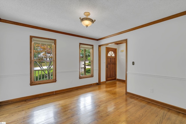 entrance foyer with light wood-style floors, visible vents, and a textured ceiling