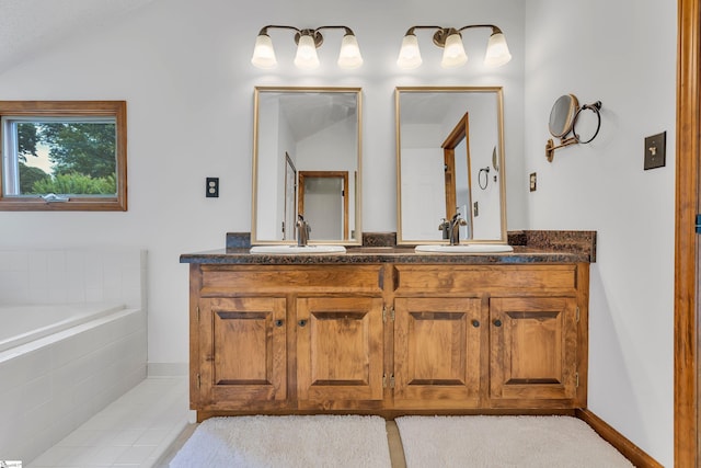 bathroom featuring double vanity, a sink, tiled bath, and tile patterned flooring