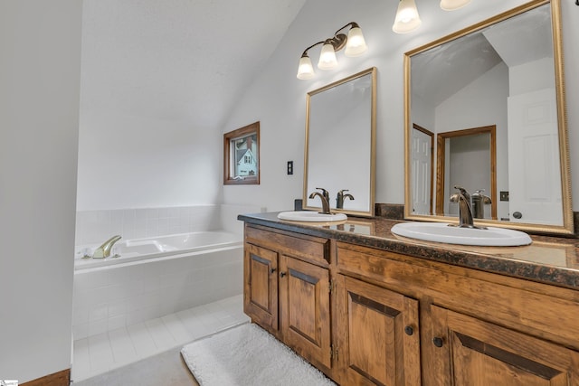 bathroom featuring a sink, a bath, and vaulted ceiling