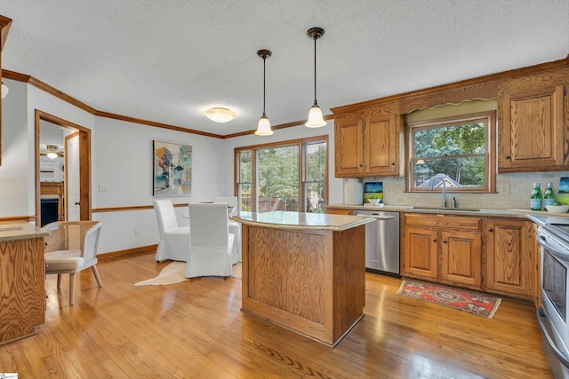 kitchen with light wood-style flooring, a kitchen island, brown cabinetry, stainless steel appliances, and a sink