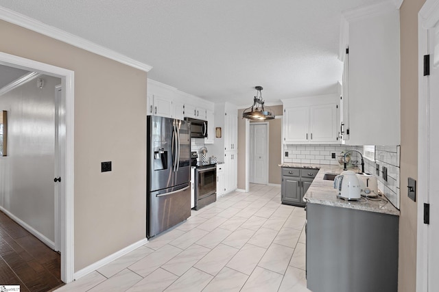 kitchen featuring ornamental molding, white cabinetry, decorative backsplash, stainless steel appliances, and a sink