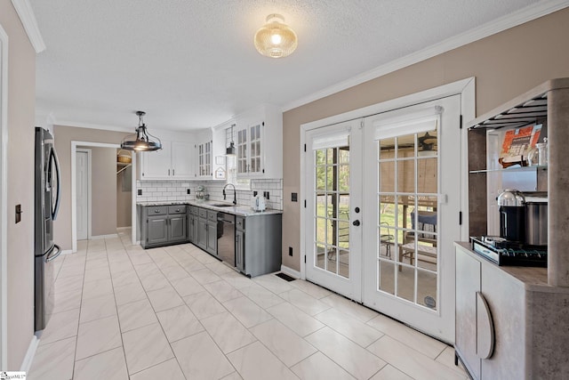 kitchen with tasteful backsplash, ornamental molding, french doors, glass insert cabinets, and gray cabinetry