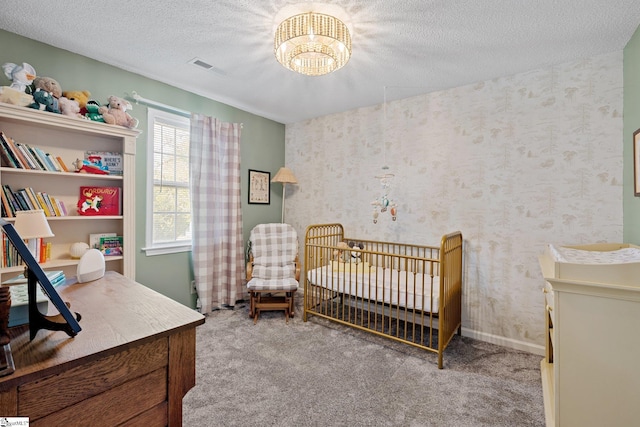 bedroom featuring a textured ceiling, an inviting chandelier, visible vents, and carpet floors