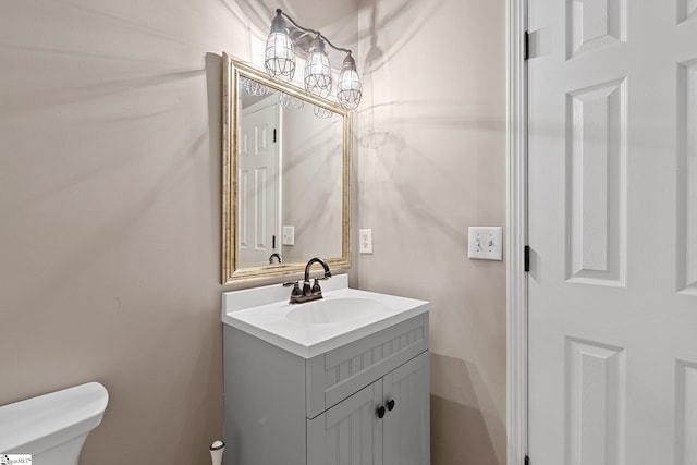 half bathroom with toilet and vanity