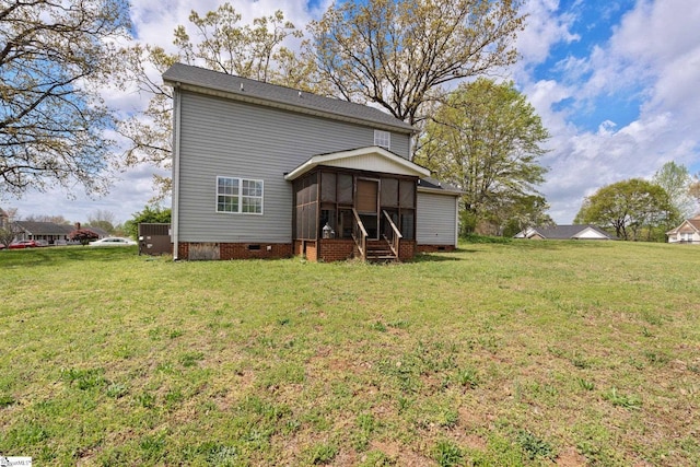 back of house featuring crawl space, a sunroom, and a lawn