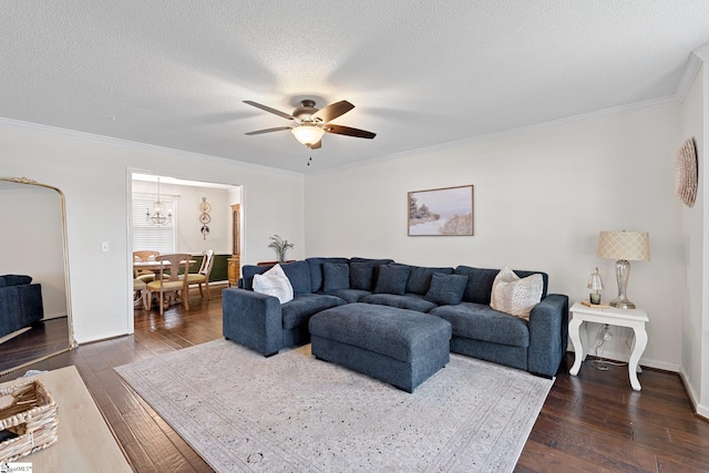 living area featuring baseboards, a textured ceiling, crown molding, dark wood finished floors, and ceiling fan with notable chandelier