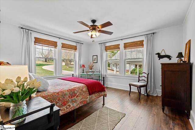 bedroom featuring wood-type flooring, baseboards, ornamental molding, and ceiling fan