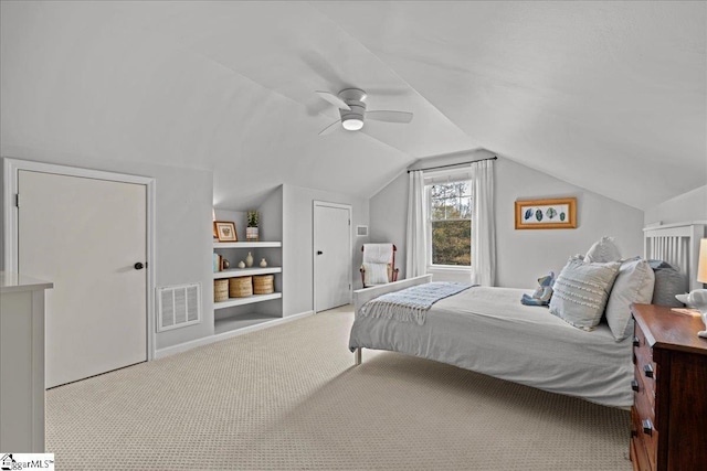 carpeted bedroom with visible vents, ceiling fan, and vaulted ceiling