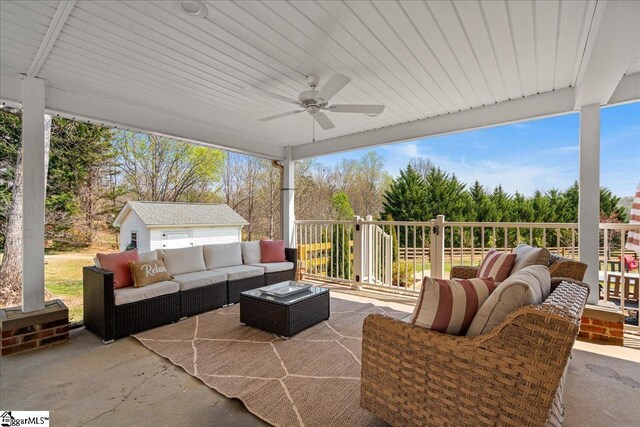 view of patio featuring an outdoor living space, a ceiling fan, and an outdoor structure