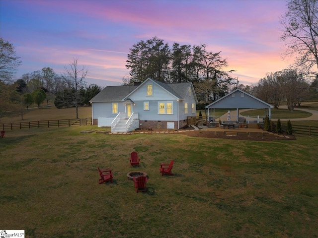 back of house with crawl space, fence, and a lawn