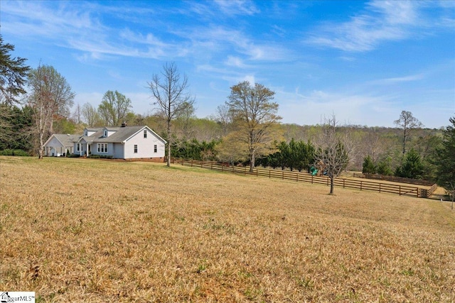 view of yard featuring a rural view and fence