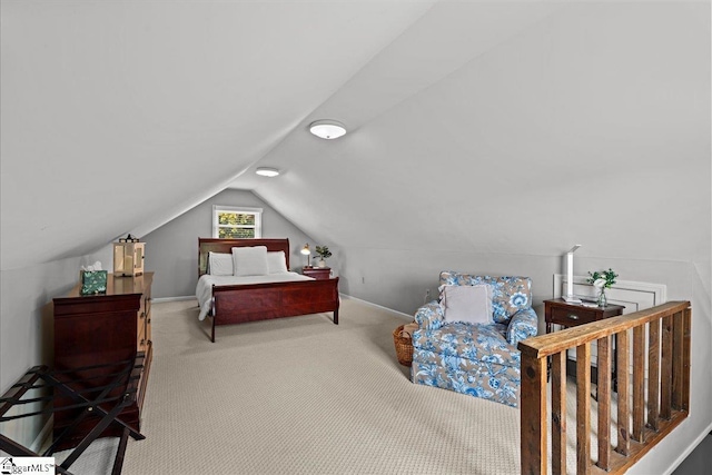 carpeted bedroom with baseboards and lofted ceiling