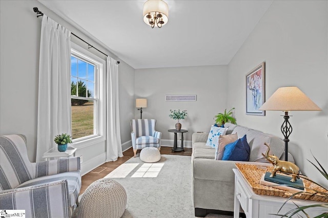 living room featuring dark wood-type flooring, visible vents, and baseboards