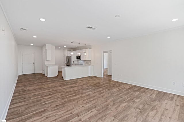 98 E Mcbee Ave Unit 205, Greenville, SC 29601 - unfurnished living room with recessed lighting, visible vents, baseboards, and wood finished floors