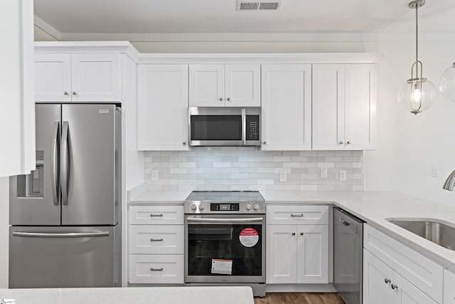 98 E Mcbee Ave Unit 205, Greenville, SC 29601 - kitchen featuring tasteful backsplash, light countertops, white cabinets, stainless steel appliances, and a sink