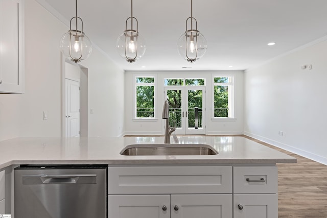 98 E Mcbee Ave Unit 205, Greenville, SC 29601 - kitchen with decorative light fixtures, crown molding, stainless steel dishwasher, and a sink