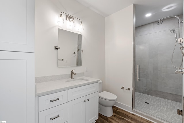 98 E Mcbee Ave Unit 205, Greenville, SC 29601 - full bathroom featuring a shower stall, vanity, toilet, wood finished floors, and baseboards