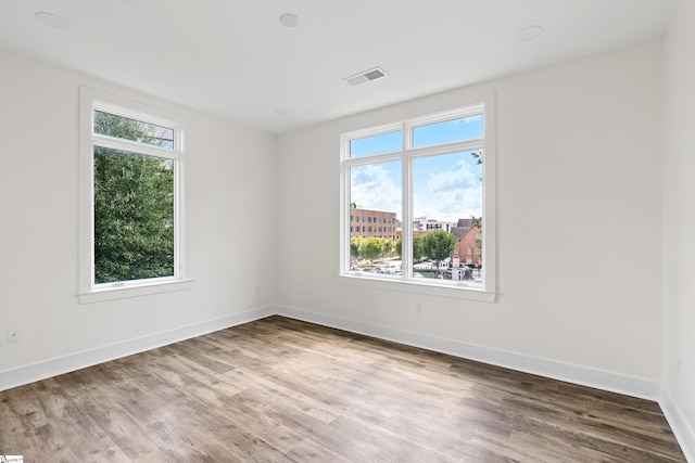 98 E Mcbee Ave Unit 205, Greenville, SC 29601 - empty room featuring visible vents, baseboards, and wood finished floors