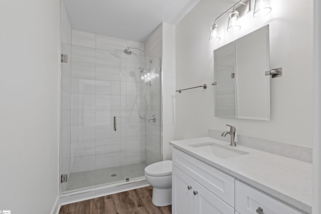 98 E Mcbee Ave Unit 205, Greenville, SC 29601 - bathroom with toilet, a stall shower, wood finished floors, and vanity