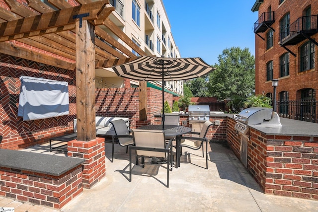 98 E Mcbee Ave Unit 205, Greenville, SC 29601 - view of patio with a grill, a pergola, outdoor dining area, and exterior kitchen