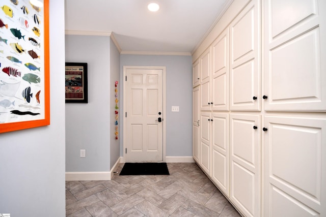entryway with crown molding and baseboards
