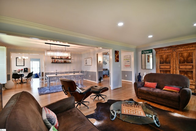 living room featuring baseboards, a chandelier, recessed lighting, crown molding, and wood finished floors