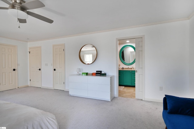 bedroom featuring crown molding, baseboards, connected bathroom, and light colored carpet