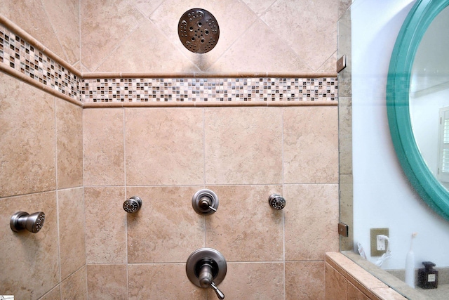 interior details featuring tiled shower