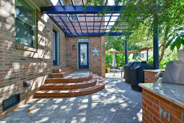 property entrance featuring brick siding and a pergola
