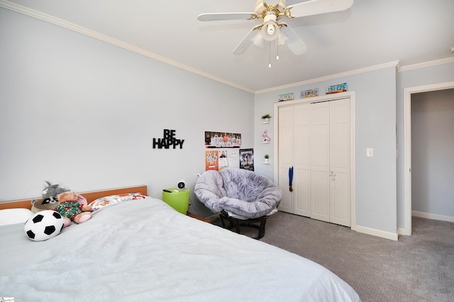 carpeted bedroom featuring a closet, baseboards, crown molding, and ceiling fan