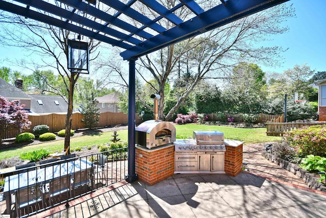 view of patio featuring area for grilling, a pergola, a fenced backyard, and a grill