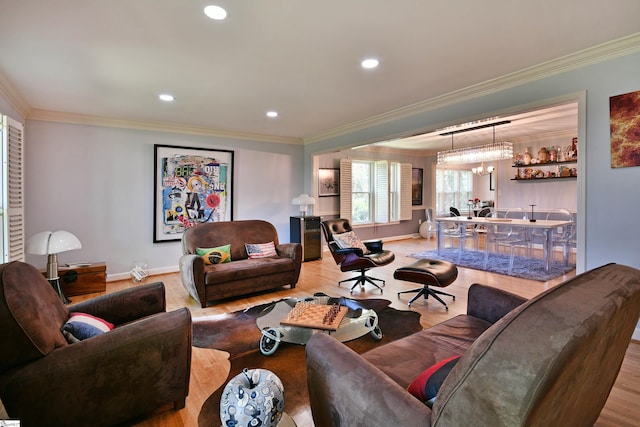 living area with wood finished floors, baseboards, ornamental molding, and recessed lighting