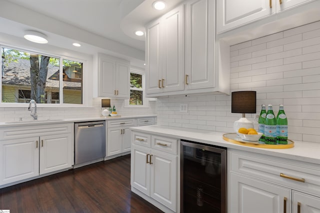 kitchen featuring white cabinets, dishwasher, beverage cooler, and light countertops