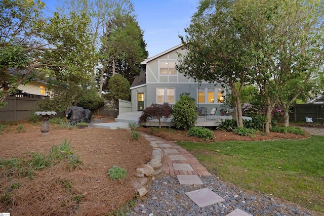 exterior space featuring fence and a front lawn