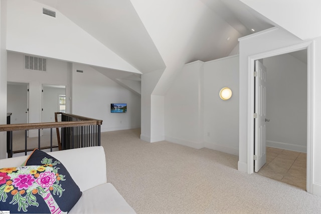 carpeted bedroom with visible vents, baseboards, and vaulted ceiling