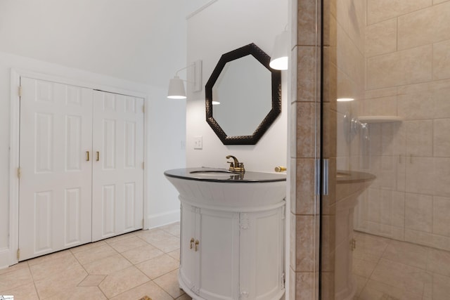 bathroom featuring a shower stall, tile patterned floors, vanity, and baseboards