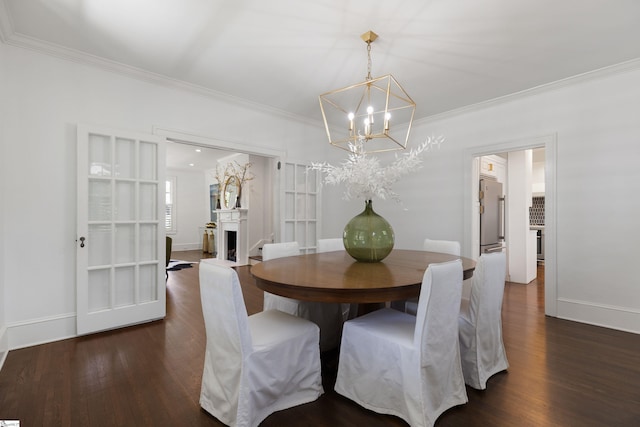 dining area with a chandelier, crown molding, wood finished floors, and baseboards