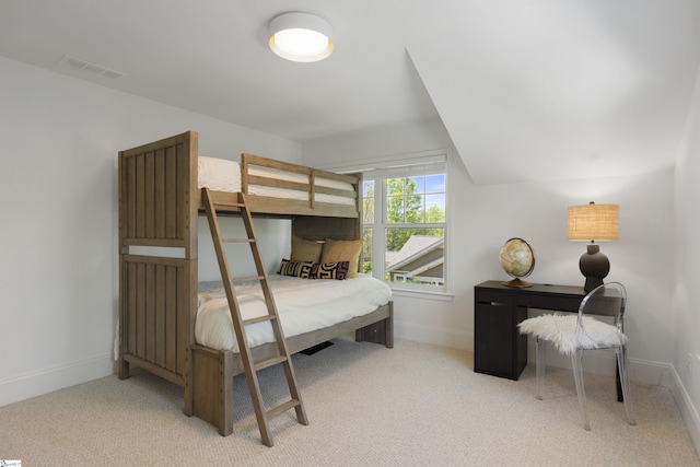 carpeted bedroom featuring baseboards, lofted ceiling, and visible vents