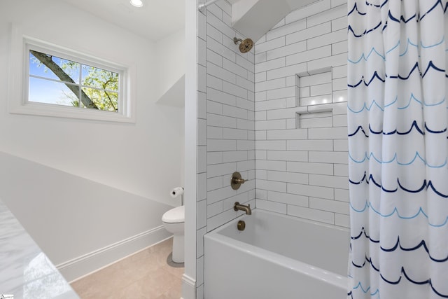 full bathroom with tile patterned floors, shower / bath combo with shower curtain, baseboards, and toilet