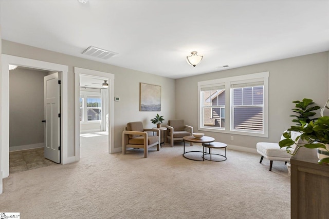 living area with carpet flooring, baseboards, and visible vents