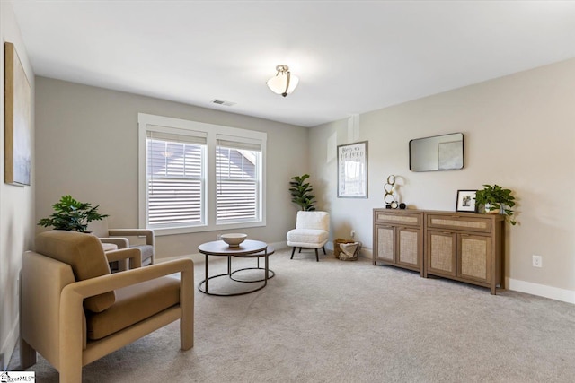 living area with visible vents, baseboards, and carpet flooring
