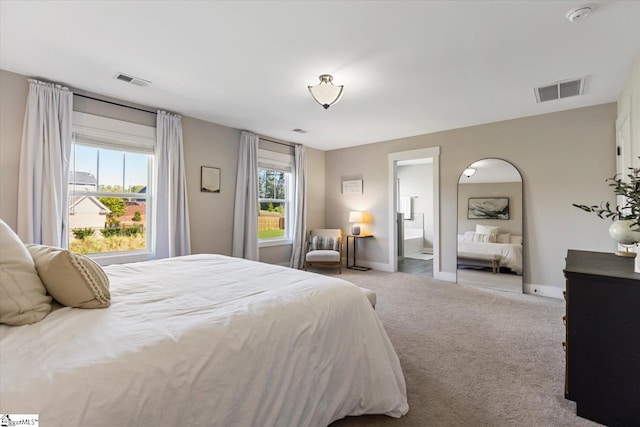 carpeted bedroom featuring baseboards and visible vents