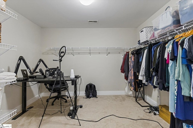 walk in closet with visible vents and carpet floors