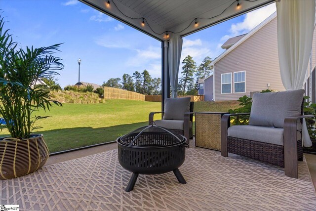 view of patio / terrace with an outdoor fire pit and fence