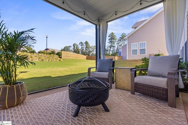 view of patio / terrace featuring an outdoor fire pit and fence