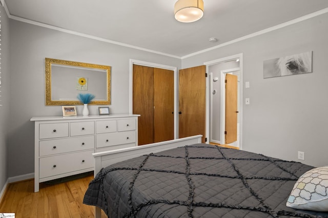 bedroom featuring light wood-type flooring, baseboards, and ornamental molding