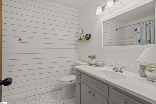 full bathroom featuring vanity, tile patterned flooring, toilet, a shower with shower curtain, and wooden walls