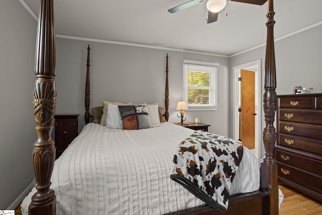 bedroom with light wood-style floors, ornamental molding, and ceiling fan